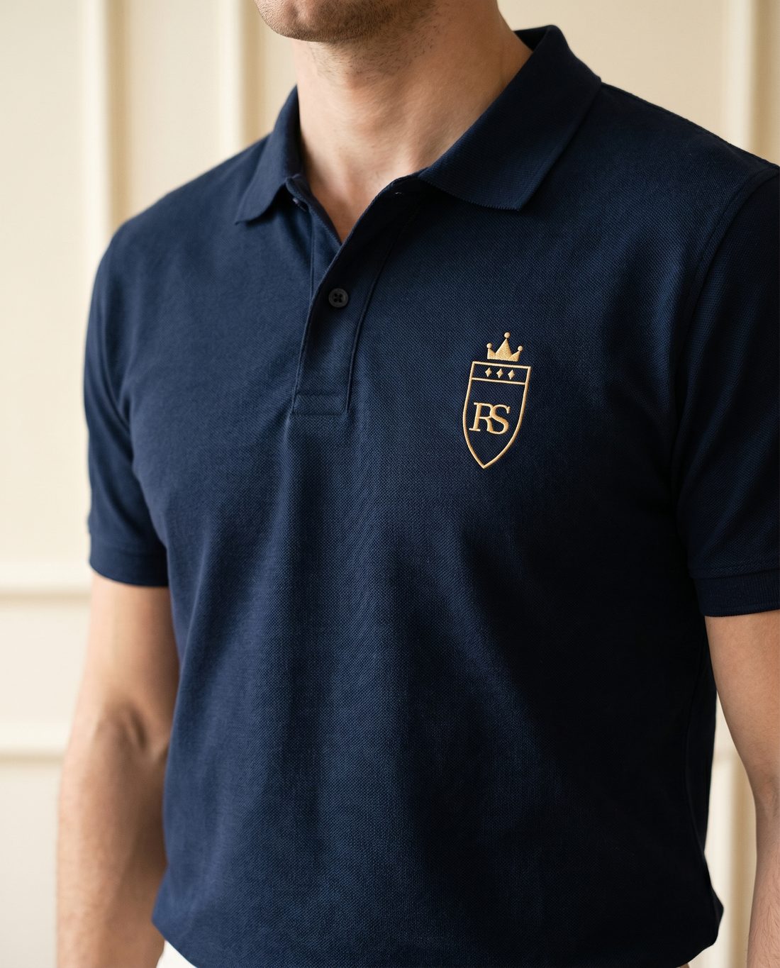 Polo marine brodé du monogramme RS porté en intérieur haussmannien — style old money, Maison Sahari