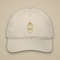 Casquette brodée RS Écru brodée du monogramme RS, vue de face sur fond pierre — Maison Sahari