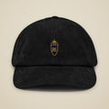 Casquette en velours côtelé Noir brodée du monogramme RS, vue de face sur fond pierre — Maison Sahari