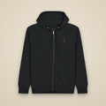 Sweat zippé Noir brodé du monogramme RS, vue de face sur fond pierre — Maison Sahari