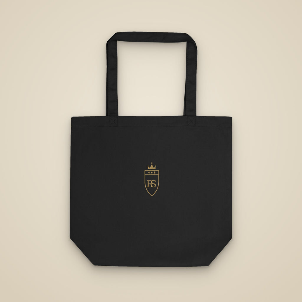 Tote bag noir brodé du monogramme RS, vue de face sur fond pierre — Maison Sahari