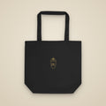 Tote bag noir brodé du monogramme RS, vue de face sur fond pierre — Maison Sahari