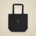 Tote bag noir brodé du monogramme RS, vue de face sur fond pierre — Maison Sahari