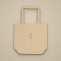 Tote bag sable brodé du monogramme RS, vue de face sur fond pierre — Maison Sahari