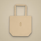 Tote bag sable brodé du monogramme RS, vue de face sur fond pierre — Maison Sahari