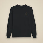 T-shirt à manches longues noir brodé du monogramme RS, vue de face sur fond pierre — Maison Sahari